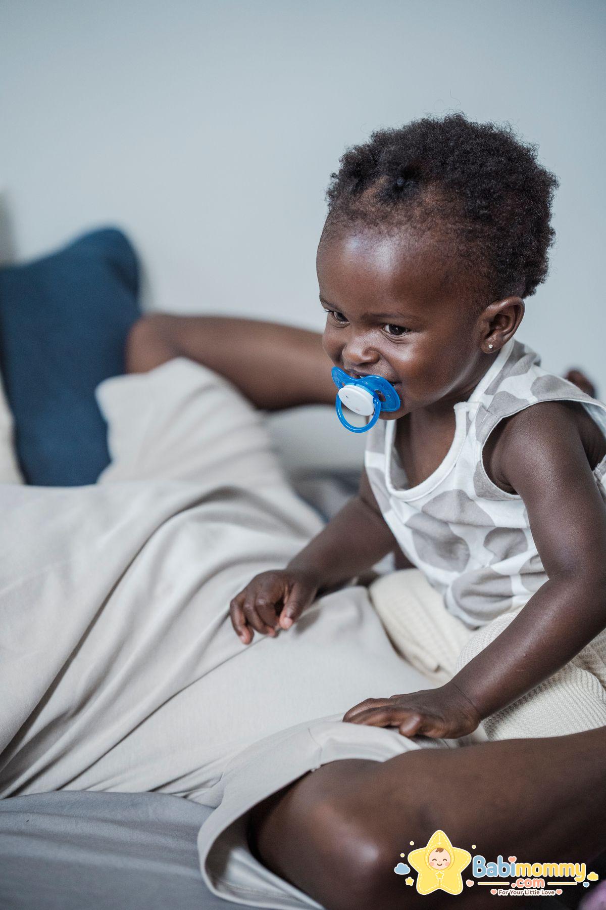 Baby with a pacifier at home