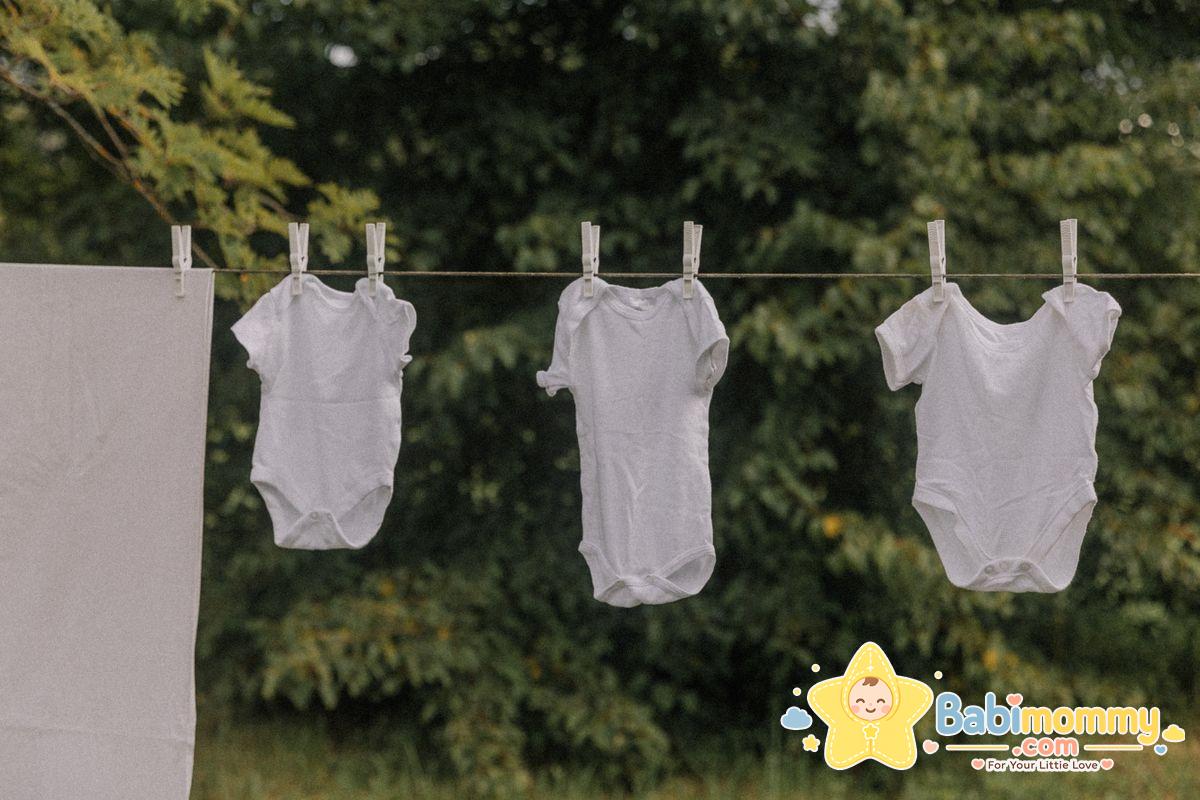 Clean baby clothes air-drying on a clothesline